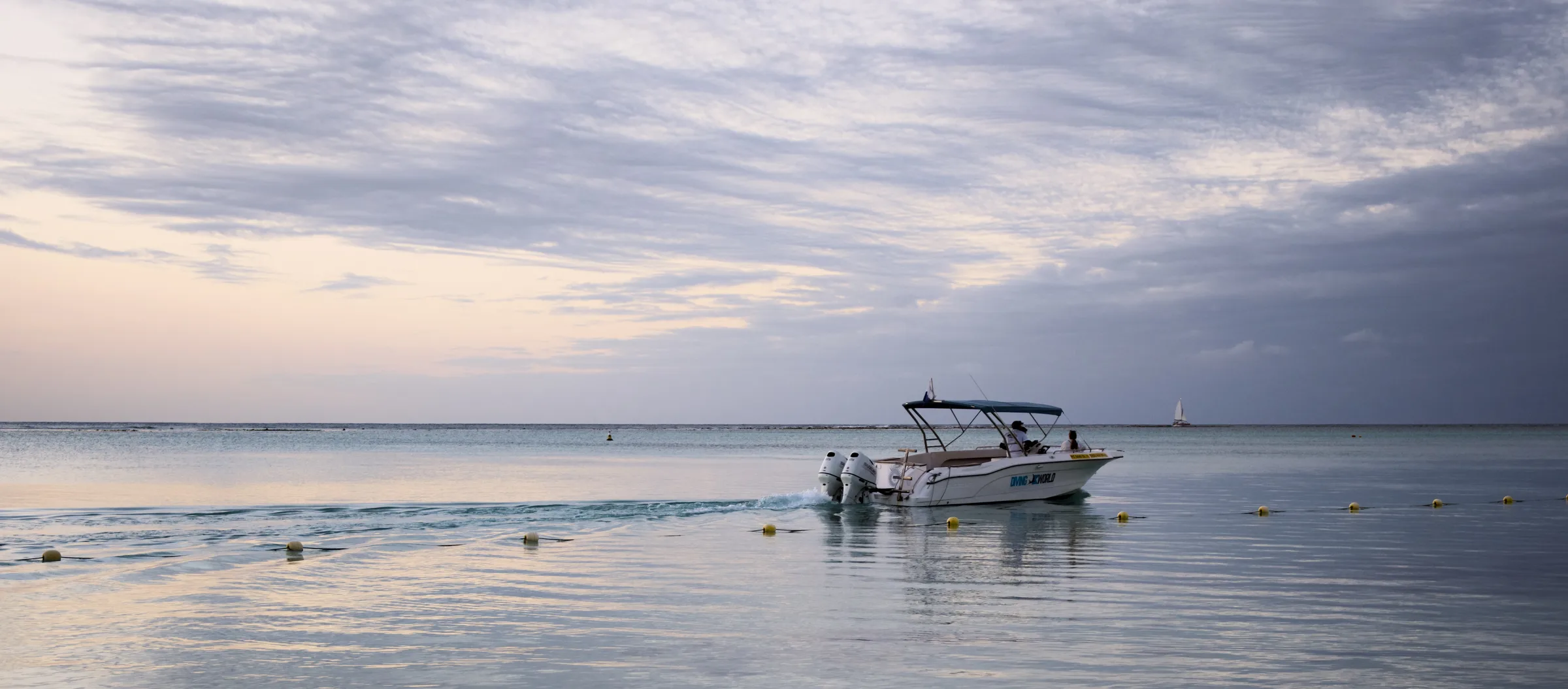 Speedboat on calm water at dusk, Mauritius